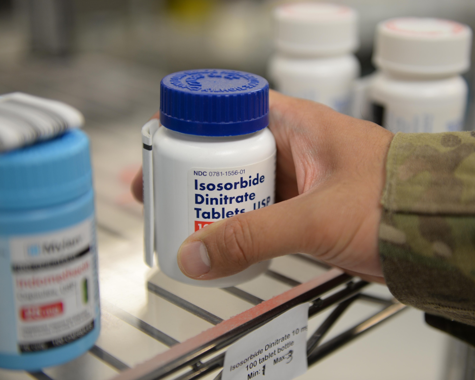 U.S. Air Force Capt. David Vuong, 455th Expeditionary Medical Operations Squadron pharmacist, grabs a bottle of prescription medication for a patient July 31, 2015, at Bagram Airfield, Afghanistan. Vuong is responsible for keeping the pharmacy fully stocked with medications to treat patients at Bagram keeping them fit to fight and support the mission. (U.S. Air Force photo by Senior Airman Cierra Presentado/Released)