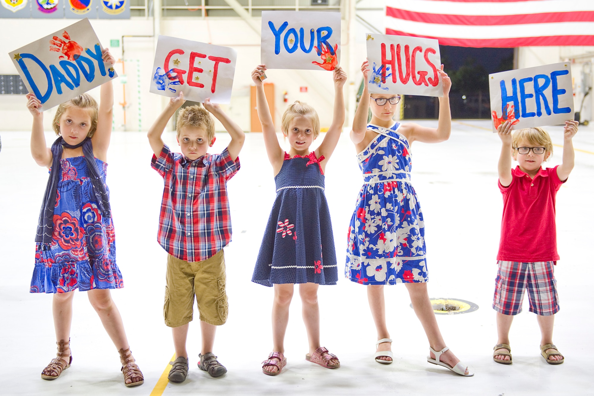 The family of Master Sgt. Robert T. Dill, III, 434th Civil Engineer Squadron power production journeyman, lines up to welcome him home to Grissom Air Reserve Base, Ind., July 22, 2015. Dill was among a group of 19 civil engineers who completed a 180-day deployment to Southwest Asia. (U.S. Air Force photo/Tech. Sgt. Benjamin Mota)