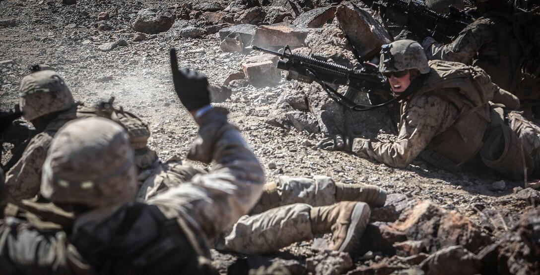 A squad leader with Company C, 1st Battalion, 3rd Marine Regiment, signals to his Marines giving them a one minute warning before assaulting an enemy position. 1/3 Marines conducted a company level live fire assault during an Integrated Training Exercise aboard Marine Corps Air Ground Combat Center Twentynine Palms, Calif., July 29.