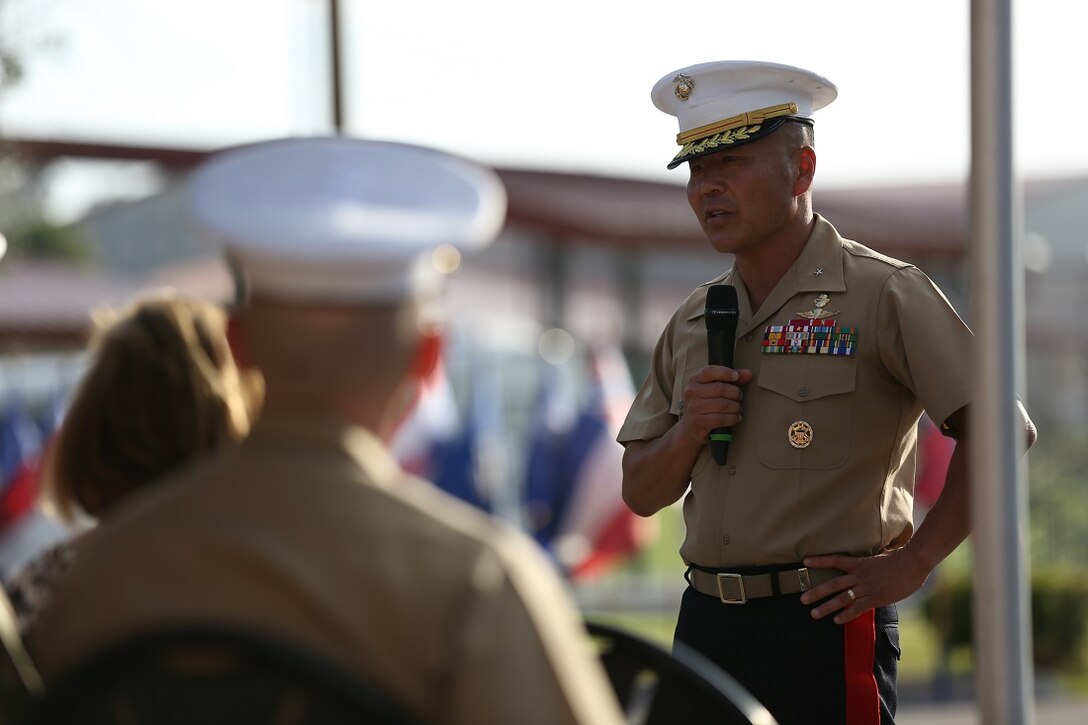 Brig. Gen. Daniel D. Yoo speaks to the guests after taking command of the 1st Marine Division from Maj. Gen. Lawrence D. Nicholson aboard Marine Corps Base Camp Pendleton, Calif., July 30, 2015. Yoo most recently served as the assistant division commander for 1st Marine Division.