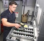 PENSACOLA, Florida - Machinist Mate Third Class Petty Officer (SW) Logan Peters uses a hand-held RFID scanner to conduct inventory aboard USS Independence. RFID technology provides the ability to dramatically reduce the time sailors spend conducting parts and equipment inventory in support of ship replenishment.