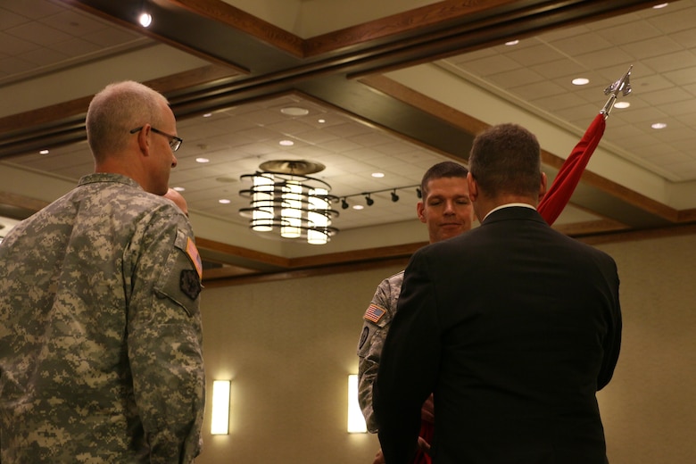 Col. John W. Henderson hands the flag of the U.S. Army Corps of Engineers to Ted Streckfuss, Deputy District Engineer of the Omaha District, U.S. Army Corps of Engineers. Henderson became the commander of the Omaha District in a ceremony held July 31 in Omaha, Neb.