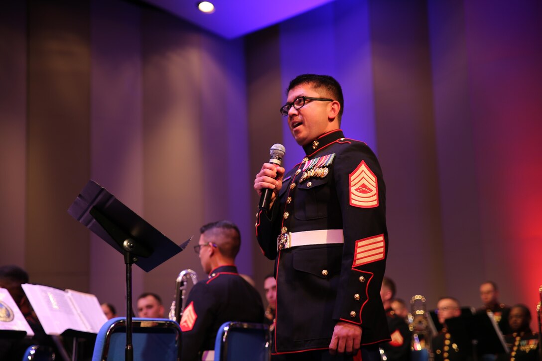 Bandmaster Master Sgt. William Call introduces the Marine Corps Band New Orleans during a concert at the University of Montana May 2, 2015. The MCBNOLA conducted their spring tour through Canada and the northern United States April 29 – May 11, 2015. The tour included combined concerts with the Royal Canadian Navy Reserve Band HMCS Tecumseh, as well as the University of Montana wind ensemble. The tour held concerts in Calgary, Missoula, Mt.; Billings, Mt.; Rapid City, SD and Cheyenne, Wy.