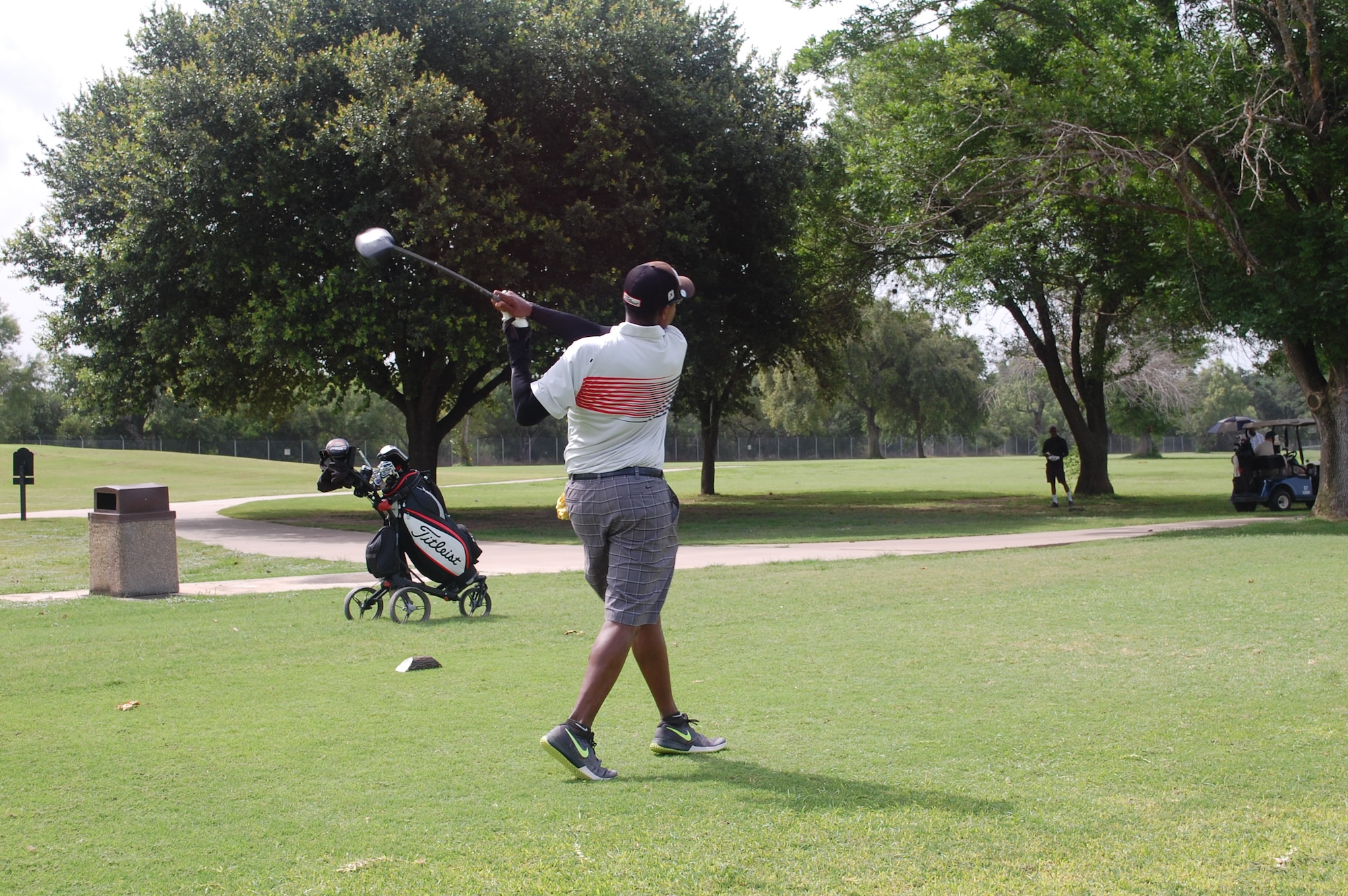 Retired Staff Sgt. Reggie Davis, a member at the Gateway Hills for four years, tees off July 8, 2015, at Gateway Hills Joint Base San Antonio-Lackland. He regularly golfs with his uncle, Richard Davis, and father, Charles Davis. The elder Davises are retired from the Air Force. (U.S. Air Force photo/Carole Chiles Fuller/RELEASED) 
