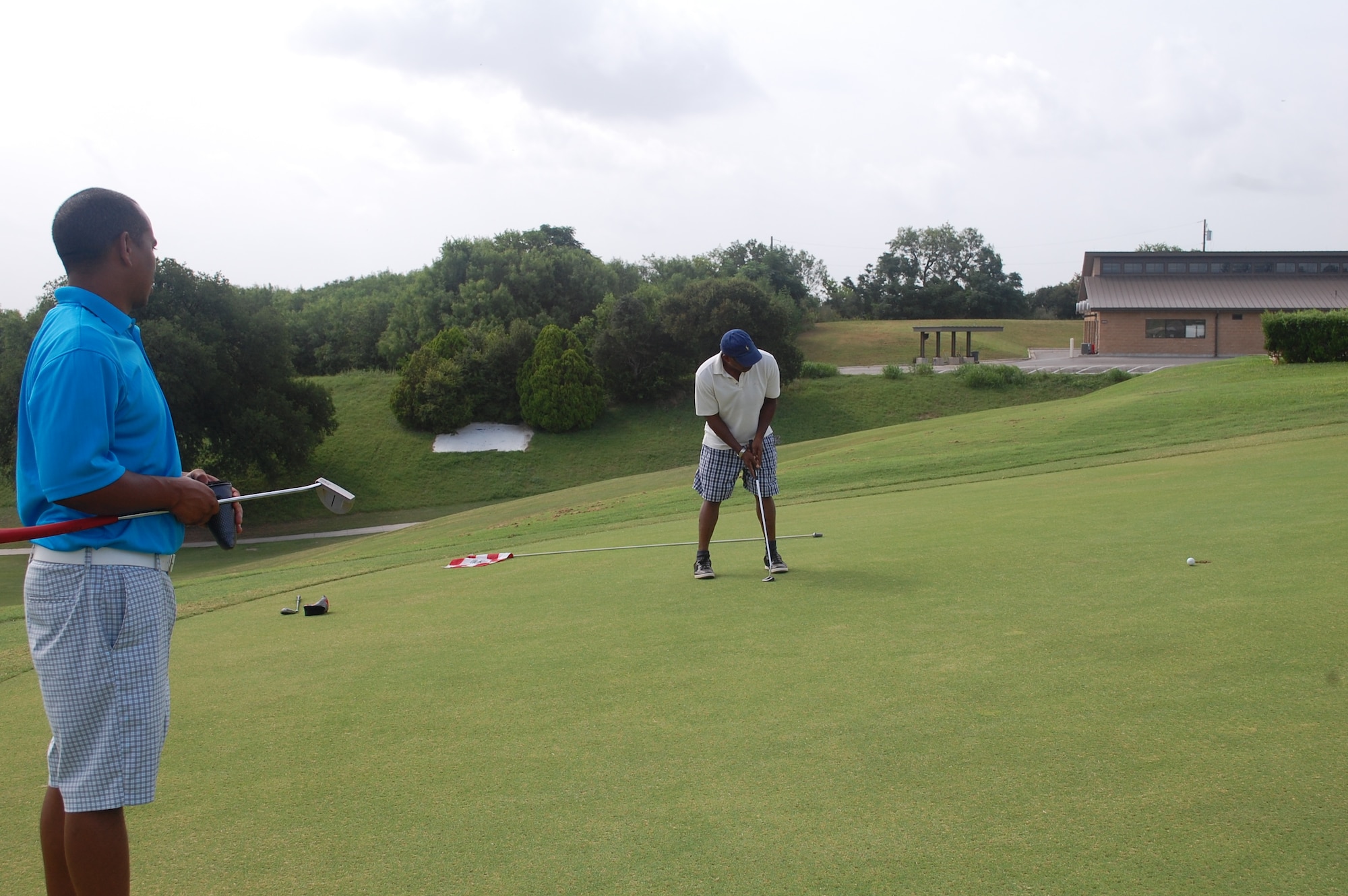 Army Maj. Primitivo Davis, a chaplain from Fort Jackson, South Carolina (left), and pastor Errol Stoddart play a round of golf July 8, 2015, at Gateway Hills on Joint Base San Antonio-Lackland, Texas. They were in San Antonio for a conference. (U.S. Air Force photo/Carole Chiles Fuller/RELEASED) 
