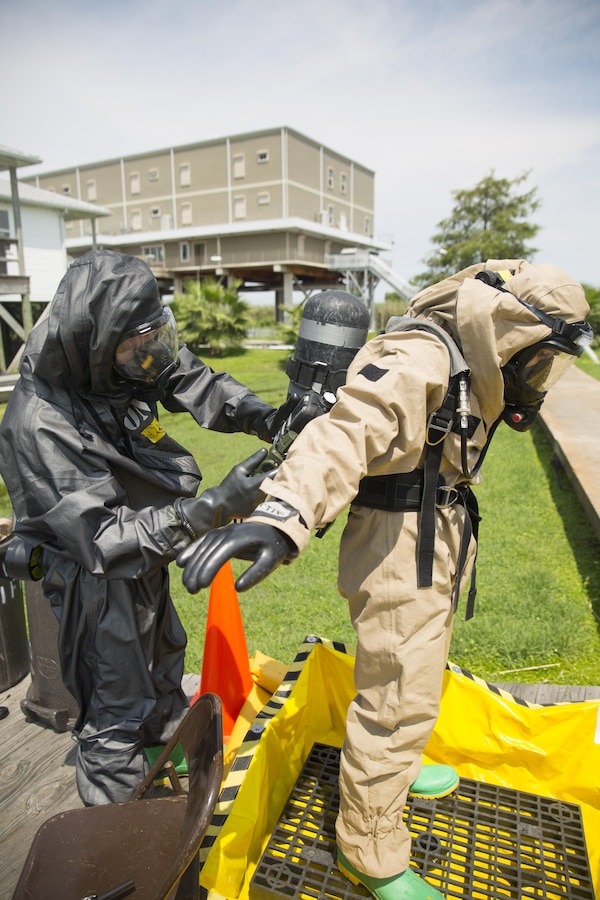 Lance Cpl. Cody A. Tankersley, a chemical, biological, radiological and nuclear defense specialist with Headquarters and Service Company, 4th Light Armored Reconnaissance Battalion, 4th Marine Division, checks Lance Cpl. Georgiy Abgaryan, a CBRN defense specialist with Headquarters and Service Company, 2nd Battalion, 23rd Marine Regiment, 4th Marine Division, for contaminants during the final training event of the Advanced Consequence Management Team Certification in Pilottown, La., July 29, 2015. During the training event, Abgaryan was part of a reconnaissance team that responded to a simulated methamphetamine laboratory. (U.S. Marine Corps photo by Cpl. Ian Leones/Released)