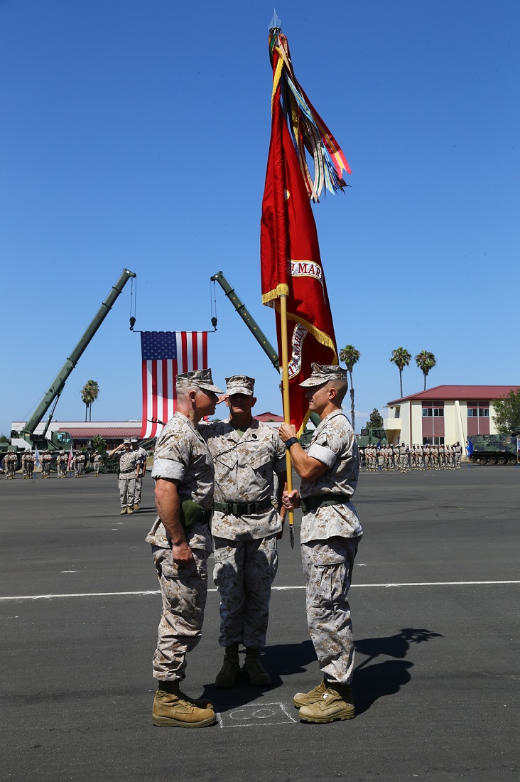 U.S. Marine Corps Col. Matthew G. Trollinger, commanding officer, 11th Marine Expeditionary Unit (MEU), passes the Marine Corps colors to Col. Clay C. Tipton for a change of command ceremony aboard Camp Pendleton, Calif., July 17. Trollinger relinquished his command of the 11th MEU to Tipton. (U.S. Marine Corps photo by Cpl. Jonathan R. Waldman/Released)