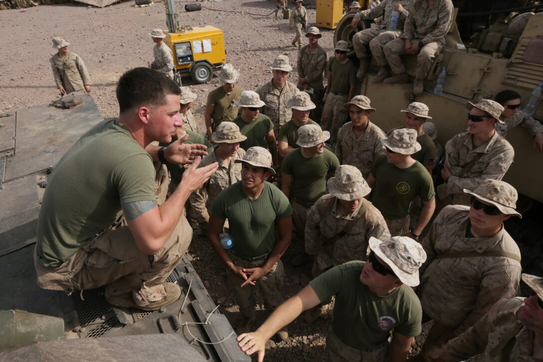 ARTA BEACH, Djibouti (July 24, 2015) U.S. Marine Lance Cpl. Donald Varilek teaches the Marines of Battalion Landing Team 3rd Battalion, 1st Marine Regiment, 15th Marine Expeditionary Unit, about the functions of an M1A1 Abrams tank. Varilek is a tank loader with BLT 3/1, 15th MEU. Elements of the 15th Marine Expeditionary Unit are ashore in Djibouti for sustainment training to maintain and enhance the skills they developed during their pre-deployment training period.  The 15th MEU is currently deployed in support of maritime security operations and theater security cooperation efforts in the U.S. 5th and 6th Fleet areas of operation. (U.S. Marine Corps photo by Sgt. Jamean Berry/Released)