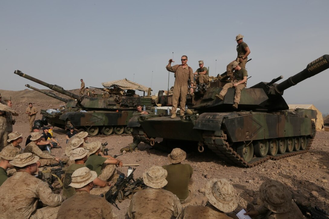 ARTA BEACH, Djibouti (July 24, 2015) U.S. Marine 1st Lt. Stephen Stone, center, teaches the Marines of Battalion Landing Team 3rd Battalion, 1st Marine Regiment, 15th Marine Expeditionary Unit, about the functions of an M1A1 Abrams tank.  Stone is a tank platoon commander with BLT 3/1, 15th MEU.  Elements of the 15th Marine Expeditionary Unit are ashore in Djibouti for sustainment training to maintain and enhance the skills they developed during their pre-deployment training period.  The 15th MEU is currently deployed in support of maritime security operations and theater security cooperation efforts in the U.S. 5th and 6th Fleet areas of operation. (U.S. Marine Corps photo by Sgt. Jamean Berry/Released)