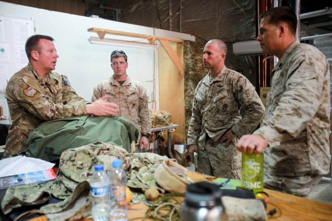 Camp Lemonnier, DJIBOUTI (July 24, 2015) U.S. Marines with the Force Reconnaissance Detachment, 15th Marine Expeditionary Unit, share knowledge with U.S. Air Force Master Sgt. Joel Corbett on general operating procedures between their units. The Force Recon Det is ashore in Djibouti sustaining their parachute and diving skills during the 15th MEU’s deployment in support of maritime security operations and theater security cooperation efforts in the U.S. 5th and 6th Fleet area of operations. (U.S. Marine Corps photo by 1st Lt. Allison Burgos/Released)