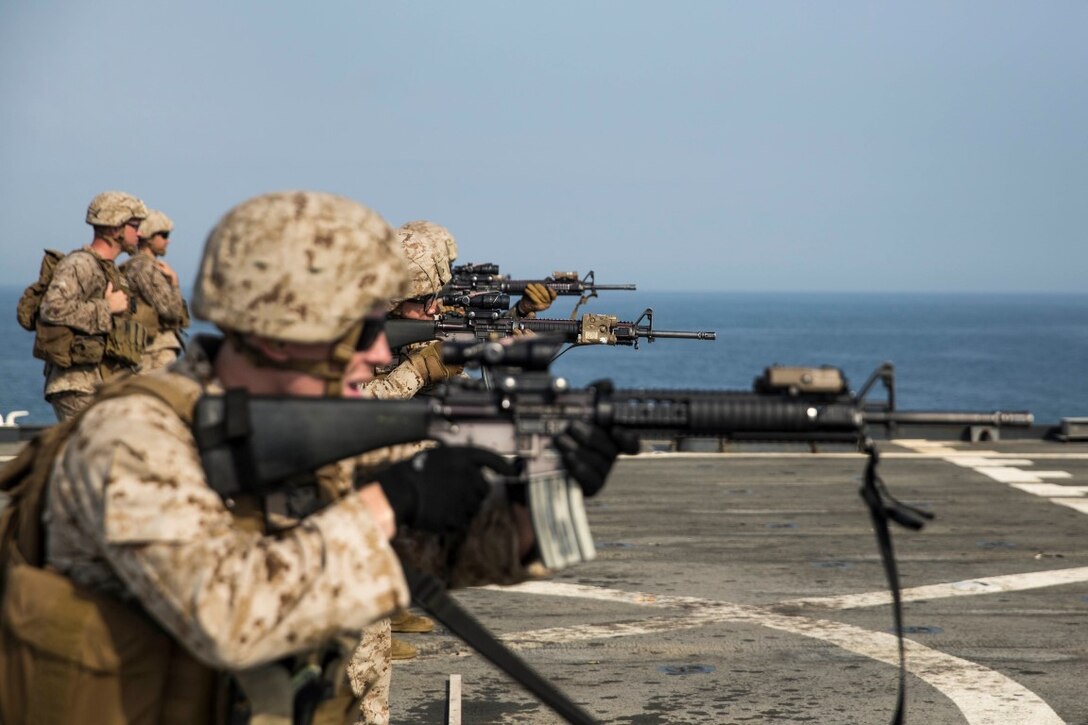 ARABIAN GULF (July 28, 2015) U.S. Marines with Kilo Company, Battalion Landing Team 3rd Battalion, 1st Marine Regiment, 15th Marine Expeditionary Unit, fire at their targets during a short-range marksmanship qualification course aboard the dock landing ship USS Rushmore (LSD 47). The training focused on sustaining combat marksmanship skills during combat-shooting rehearsals, as well as immediate-action tactics, which prepare these Marines for potential operations while deployed with the 15th MEU. The 15th MEU is embarked on the Essex Amphibious Ready Group and deployed to maintain regional security in the U.S. 5th Fleet area of operations.  (U.S. Marine Corps photo by Sgt. Emmanuel Ramos/Released)