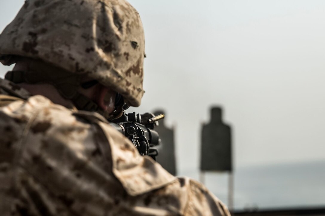 ARABIAN GULF (July 28, 2015) U.S. Marine Lance Cpl. Shawn Smith fires at his target during a short-range marksmanship qualification course aboard the dock landing ship USS Rushmore (LSD 47). Smith is a field radio operator with Kilo Company, Battalion Landing Team 3rd Battalion, 1st Marine Regiment, 15th Marine Expeditionary Unit. The training focused on sustaining combat marksmanship skills during combat-shooting rehearsals, as well as immediate-action tactics, which prepare these Marines for potential operations while deployed with the 15th MEU. The 15th MEU is embarked on the Essex Amphibious Ready Group and deployed to maintain regional security in the U.S. 5th Fleet area of operations.  (U.S. Marine Corps photo by Sgt. Emmanuel Ramos/Released)