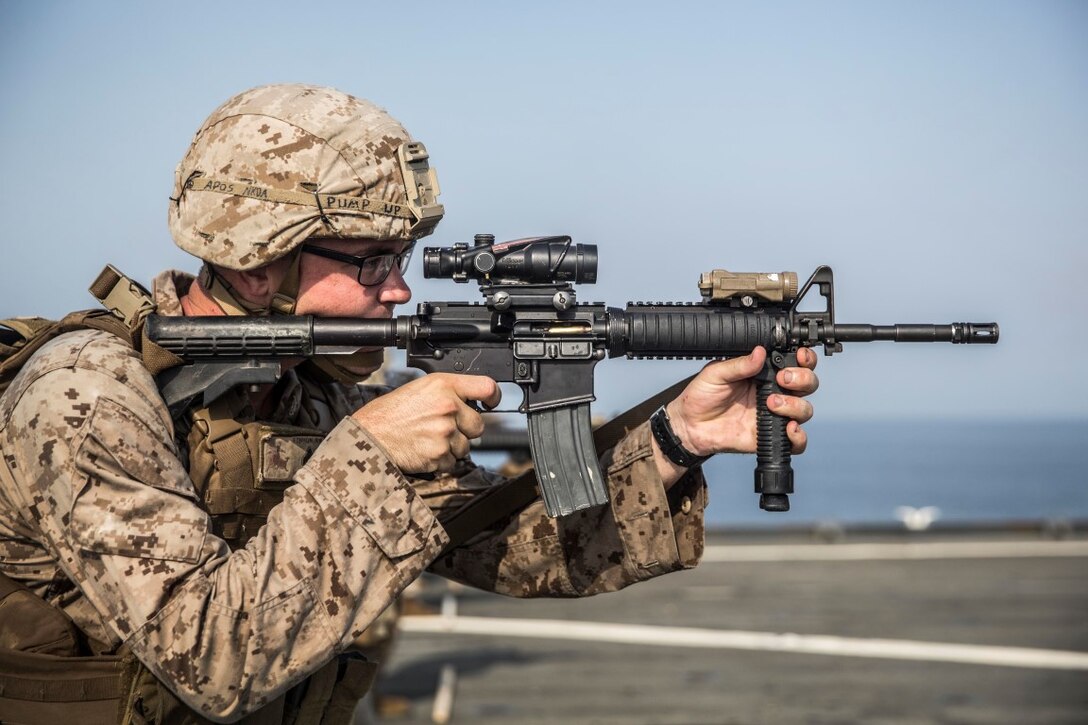 ARABIAN GULF (July 28, 2015) U.S. Marine Cpl. Patrick Kennon fires at his target during a short-range marksmanship qualification course aboard the dock landing ship USS Rushmore (LSD 47). Kennon is a machine gunner with Kilo Company, Battalion Landing Team 3rd Battalion, 1st Marine Regiment, 15th Marine Expeditionary Unit. The training focused on sustaining combat marksmanship skills during combat-shooting rehearsals, as well as immediate-action tactics, which prepare these Marines for potential operations while deployed with the 15th MEU. The 15th MEU is embarked on the Essex Amphibious Ready Group and deployed to maintain regional security in the U.S. 5th Fleet area of operations.  (U.S. Marine Corps photo by Sgt. Emmanuel Ramos/Released)