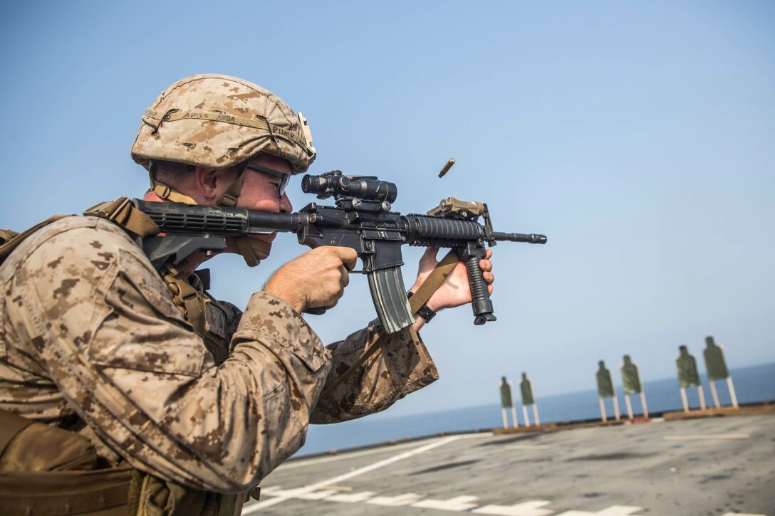 ARABIAN GULF (July 28, 2015) U.S. Marine Cpl. Patrick Kennon fires at his target during a short-range marksmanship qualification course aboard the dock landing ship USS Rushmore (LSD 47). Kennon is a machine gunner with Kilo Company, Battalion Landing Team 3rd Battalion, 1st Marine Regiment, 15th Marine Expeditionary Unit. The training focused on sustaining combat marksmanship skills during combat-shooting rehearsals, as well as immediate-action tactics, which prepare these Marines for potential operations while deployed with the 15th MEU. The 15th MEU is embarked on the Essex Amphibious Ready Group and deployed to maintain regional security in the U.S. 5th Fleet area of operations. (U.S. Marine Corps photo by Sgt. Emmanuel Ramos/Released)