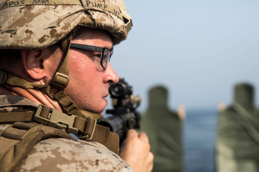 ARABIAN GULF (July 28, 2015) U.S. Marine Cpl. Patrick Kennon assess additional threats after firing at his target during a short-range marksmanship qualification course aboard the dock landing ship USS Rushmore (LSD 47). Kennon is a machine gunner with Kilo Company, Battalion Landing Team 3rd Battalion, 1st Marine Regiment, 15th Marine Expeditionary Unit. The training focused on sustaining combat marksmanship skills during combat-shooting rehearsals, as well as immediate-action tactics, which prepare these Marines for potential operations while deployed with the 15th MEU. The 15th MEU is embarked on the Essex Amphibious Ready Group and deployed to maintain regional security in the U.S. 5th Fleet area of operations.  (U.S. Marine Corps photo by Sgt. Emmanuel Ramos/Released)