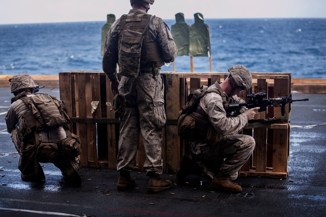INDIAN OCEAN (July 30, 2015) U.S. Marines with Lima Company, Battalion Landing Team 3rd Battalion, 1st Marine Regiment, 15th Marine Expeditionary Unit, practice barricade shooting aboard the amphibious assault ship USS Essex (LHD 2). The Marines practiced shooting from behind a barricade to simulate staying behind cover during a firefight. The 15th MEU is embarked on the Essex Amphibious Ready Group and deployed to maintain regional security in the U.S. 5th Fleet area of operations. (U.S. Marine Corps photo by Cpl. Elize McKelvey/Released)