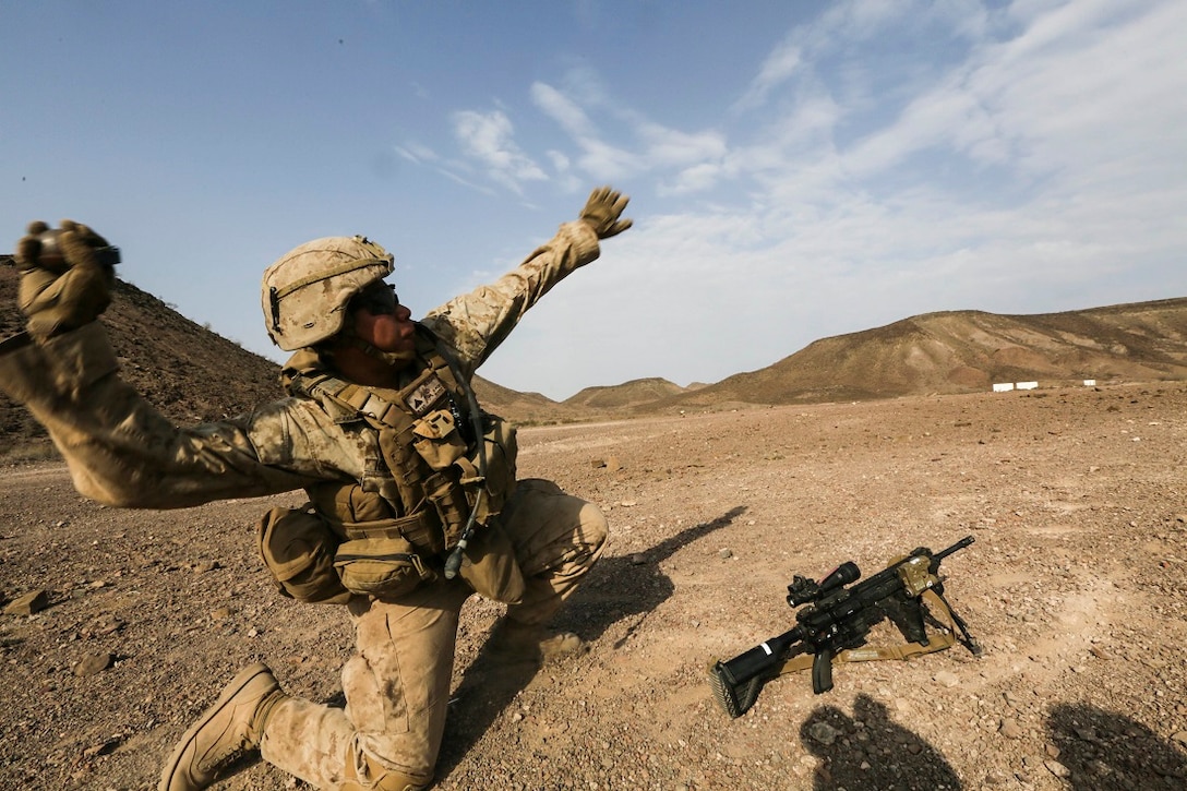 ARTA BEACH, Djibouti (July 22, 2015) A U.S. Marine with Battalion Landing Team 3rd Battalion, 1st Marine Regiment, 15th Marine Expeditionary Unit throws a practice grenade during a grenade accuracy exercise.  Elements of the 15th Marine Expeditionary Unit are ashore in Djibouti for sustainment training to maintain and enhance the skills they developed during their pre-deployment training period.  The 15th MEU is currently deployed in support of maritime security operations and theater security cooperation efforts in the U.S. 5th and 6th Fleet areas of operation. (U.S. Marine Corps photo by Sgt. Jamean Berry/Released)