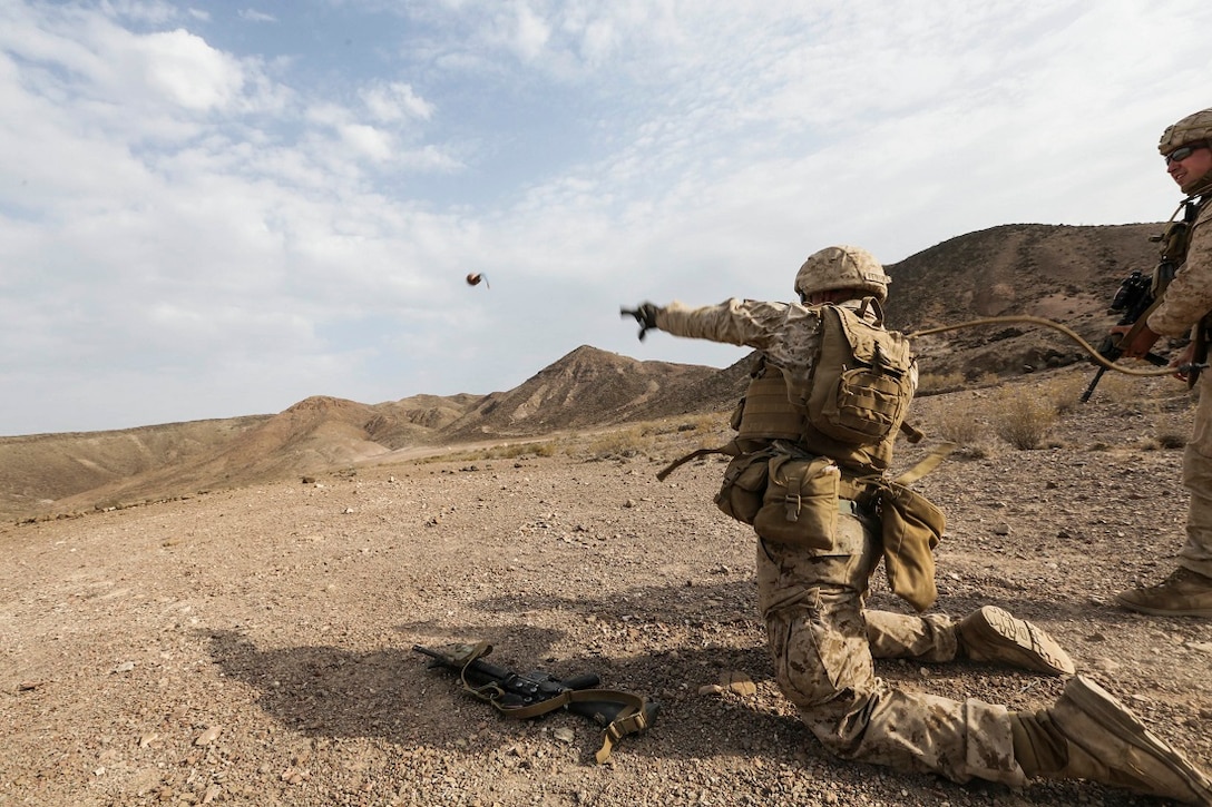 ARTA BEACH, Djibouti (July 22, 2015) U.S. Marine Lance Cpl. Spencer Feikert throws a practice grenade during a grenade accuracy exercise. Feikert is a rifleman with Battalion Landing Team 3rd Battalion, 1st Marine Regiment, 15th Marine Expeditionary Unit.  Elements of the 15th Marine Expeditionary Unit are ashore in Djibouti for sustainment training to maintain and enhance the skills they developed during their pre-deployment training period.  The 15th MEU is currently deployed in support of maritime security operations and theater security cooperation efforts in the U.S. 5th and 6th Fleet areas of operation. (U.S. Marine Corps photo by Sgt. Jamean Berry/Released)