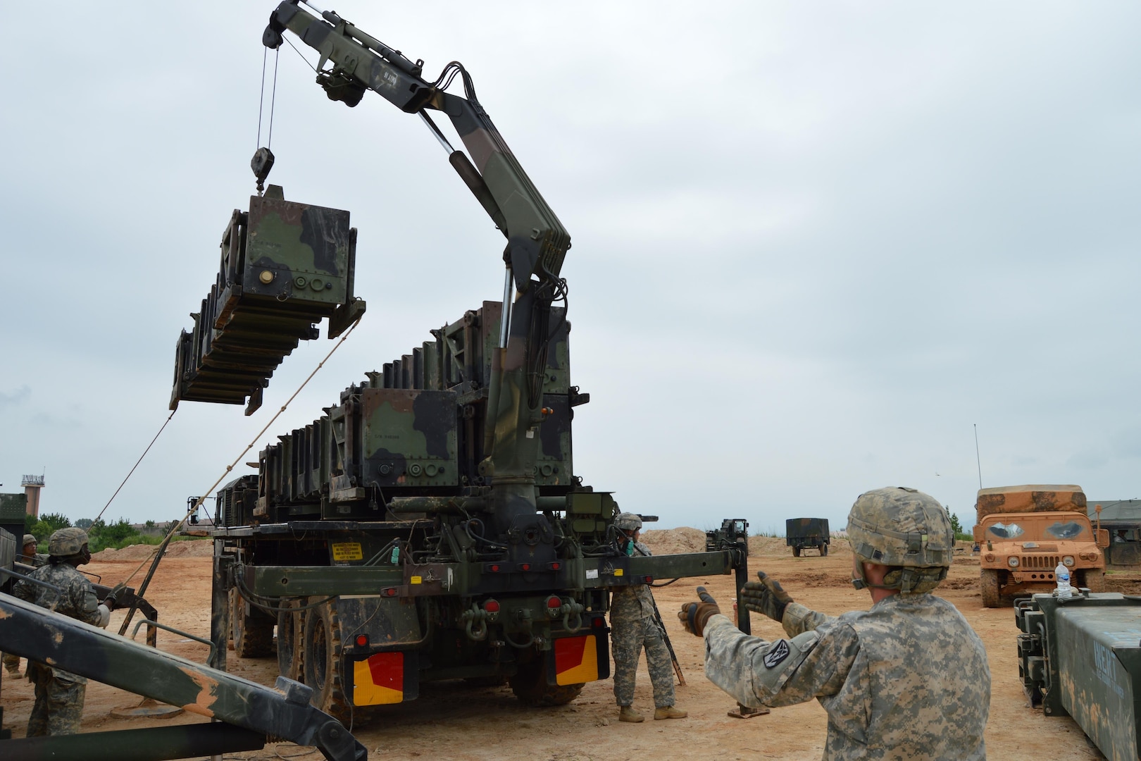 In this photos, soldiers with Battery A, 6-52 Air Defense Artillery perform guided missile transporter training as part of the unit's Iron Forge field exercise, Seosan Air Base, July 27, 2015. In addition to maintaining the unit's air and missile defense proficiencies, a mock reporter was embedded to train Soldiers to properly address the media.