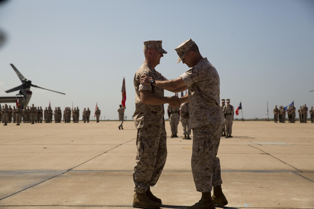Col. Anthony Bianca, former commanding officer of Marine Aircraft Group (MAG) 16, right, shakes hands with Col. Chad Blair, commanding officer of MAG-16, during the group’s change of command ceremony aboard Marine Corps Air Station Miramar, California, July 30. Bianca led MAG-16, and its subordinate units, through 13 deployments in support of Unit Deployment Programs, Marine Expeditionary Units, Operation Enduring Freedom and Special Purpose Marine Air-Ground Task Forces. (U.S. Marine Corps photo by Sgt. Brian Marion/Released)
