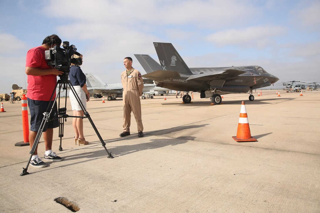 Bridget Naso, a military reporter with NBC 7 San Diego, interviews Lt. Col. Chad Vaughn, an F-35B Lightning II pilot with Marine Aircraft Group (MAG) 13, during the Marine Corps Air Station Miramar Media Day aboard MCAS Miramar, California, July 29. The MCAS Miramar Media Day allowed the media an opportunity to delve deeper into the moving parts that make the air station and the Marine Corps work. (U.S. Marine Corps photo by Cpl. Alissa P. Schuning)