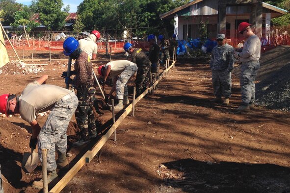 Members from the 554th Red Horse Squadron and the Philippine Army’s 53rd Engineer Brigade dig a continuous footer for a two-classroom building July 22, 2015, in Cebu Province, Philippines. U.S. military and Armed Forces of the Philippines members came together for a joint exchange project to construct a two-classroom school building and provide repairs at San Remigio Central Elementary School. (U.S. Air Force photo by 1st Lt. Christopher Post/Released)