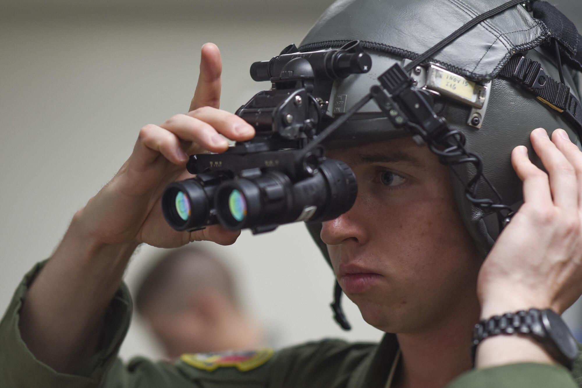 U.S. Air Force Capt. Jared Sullivan, 36th Airlift Squadron C-130 Hercules aircraft commander, adjusts a pair of night-vision goggles at Yokota Air Base, Japan, July 29, 2015. Aircrew flight equipment consists of anything from harnesses and helmets to parachutes and night-vision goggles, which need to be properly fitted before a nighttime mission. (U.S. Air Force phot by Senior Airman Michael Washburn/Released)