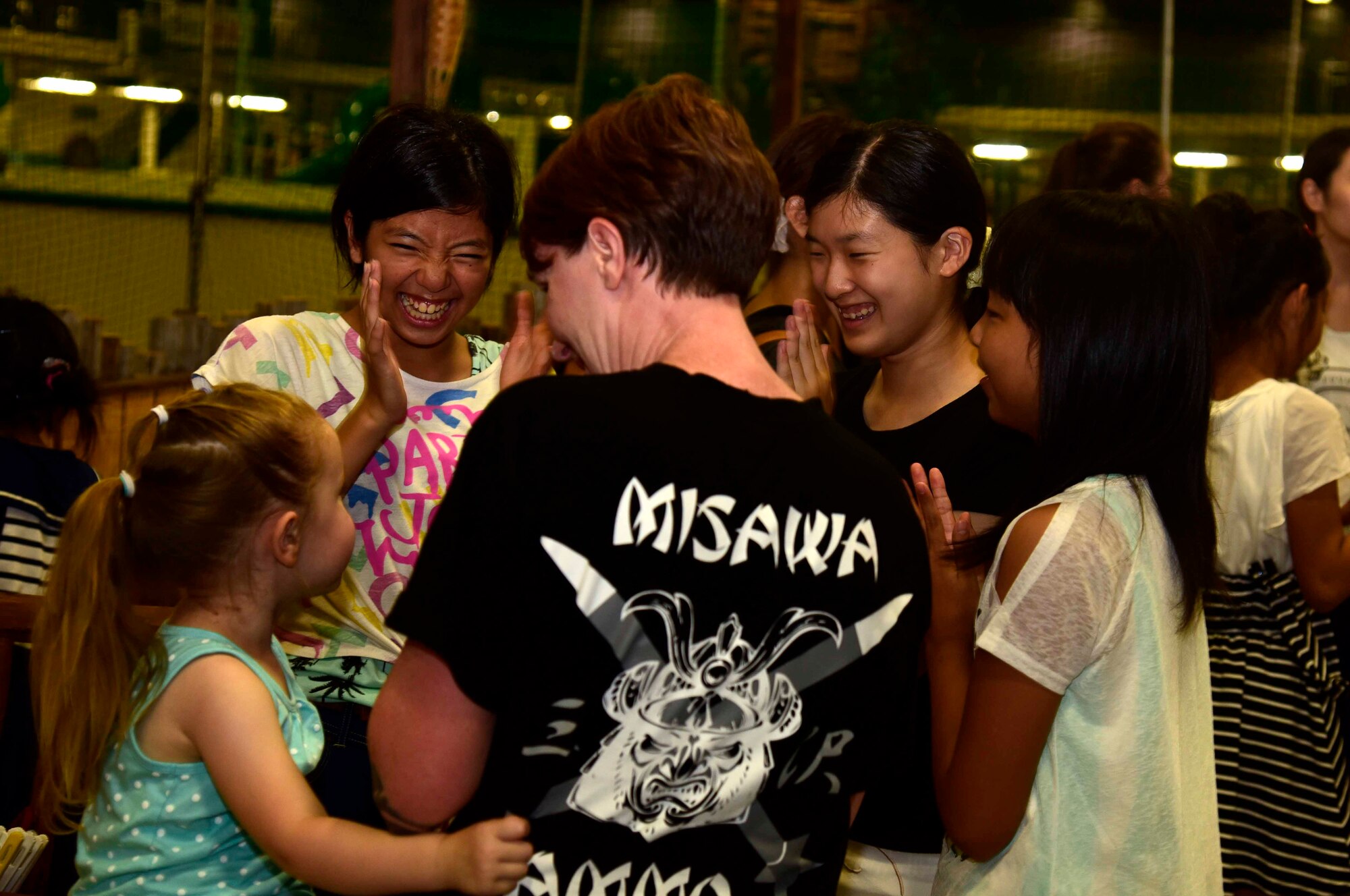 Lindsay Talbot, 35th Fighter Wing Staff Agencies unit program coordinator, interacts with children from the Shichinohe Children’s Home at Misawa Air Base, Japan, July 25, 2015. Eighteen volunteers, consisting of Airmen, Sailors and family members, spent the afternoon with the children supervising, playing games and hosting other activities. (U.S. Air Force photo by Airman 1st Class Jordyn Fetter/Released)