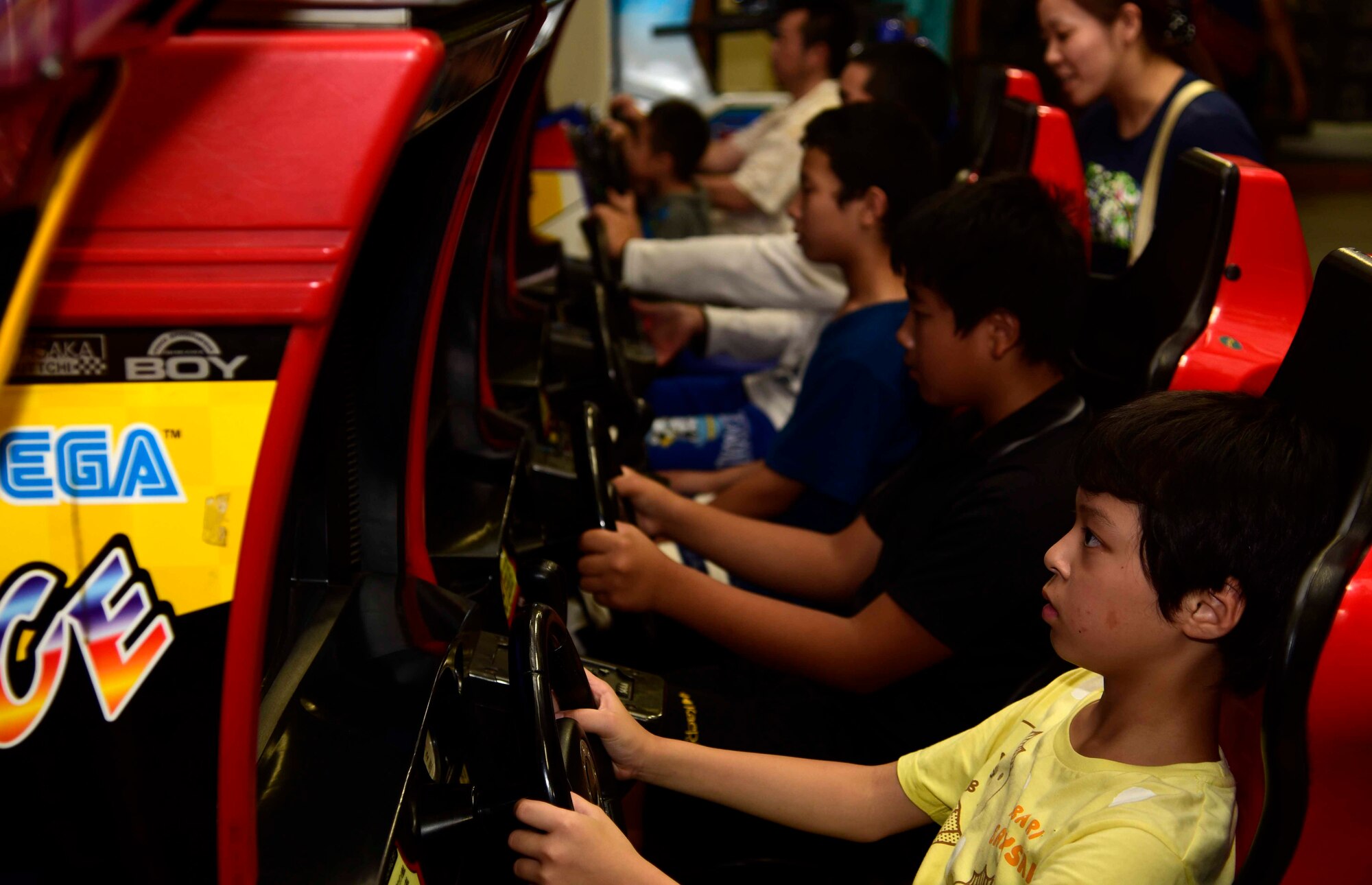 Children from the Shichinohe Children’s Home play arcade games at Misawa Air Base, Japan, July 25, 2015. Forty-five children from the home attended the "Kids of Ammo" event hosted by the 35th Maintenance Squadron munitions flight. (U.S. Air Force photo by Airman 1st Class Jordyn Fetter/Released) 
