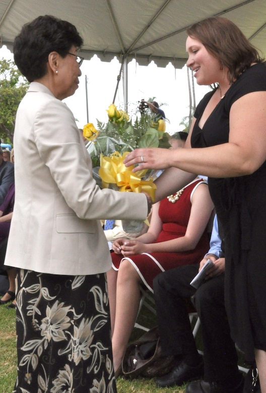 Jeanne Imamura, a civilian member of the District, is presenting a bouquet of yellow rose BUDs to Mrs.Kim Gibbs, wife of Col. Kirk Gibbs, to signify a bright new beginning.  In time, the roses will bloom and blossom as will her relationship with the district. 
Col. Kirk Gibbs assumed responsibilities as the 61th Commander and District Engineer of the U.S. Army Corps of Engineers Los Angeles District during a formal change of command ceremony held July 31 at the Community Center at Fort Mac Arthur in San Pedro, Calif.