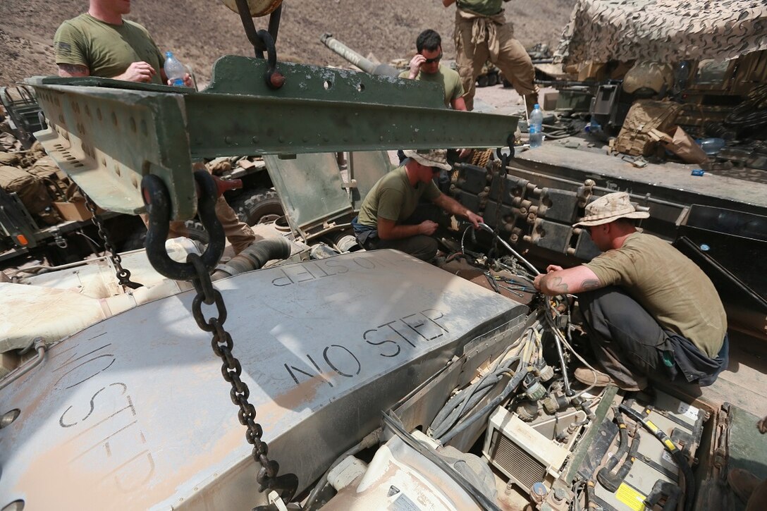 ARTA BEACH, Djibouti (July 25, 2015) U.S. Marine Sgt. Ryan Neville, right, and Sgt. Dan Micenko repair a cable on the engine of an M1A1 Abrams tank during sustainment training. Neville is a mechanic with Combat Logistics Battalion 15, and Micenko is a tank mechanic with 1st Tank Detachment, Headquarters and Service Company, Battalion Landing Team 3rd Battalion, 1st Marine Regiment, 15th Marine Expeditionary Unit. Elements of the 15th MEU are ashore in Djibouti for sustainment training to maintain and enhance the skills they developed during their pre-deployment training period.  The 15th MEU is currently deployed in support of maritime security operations and theater security cooperation efforts in the U.S. 5th and 6th Fleet areas of operation. (U.S. Marine Corps photo by Sgt. Steve H. Lopez/Released)