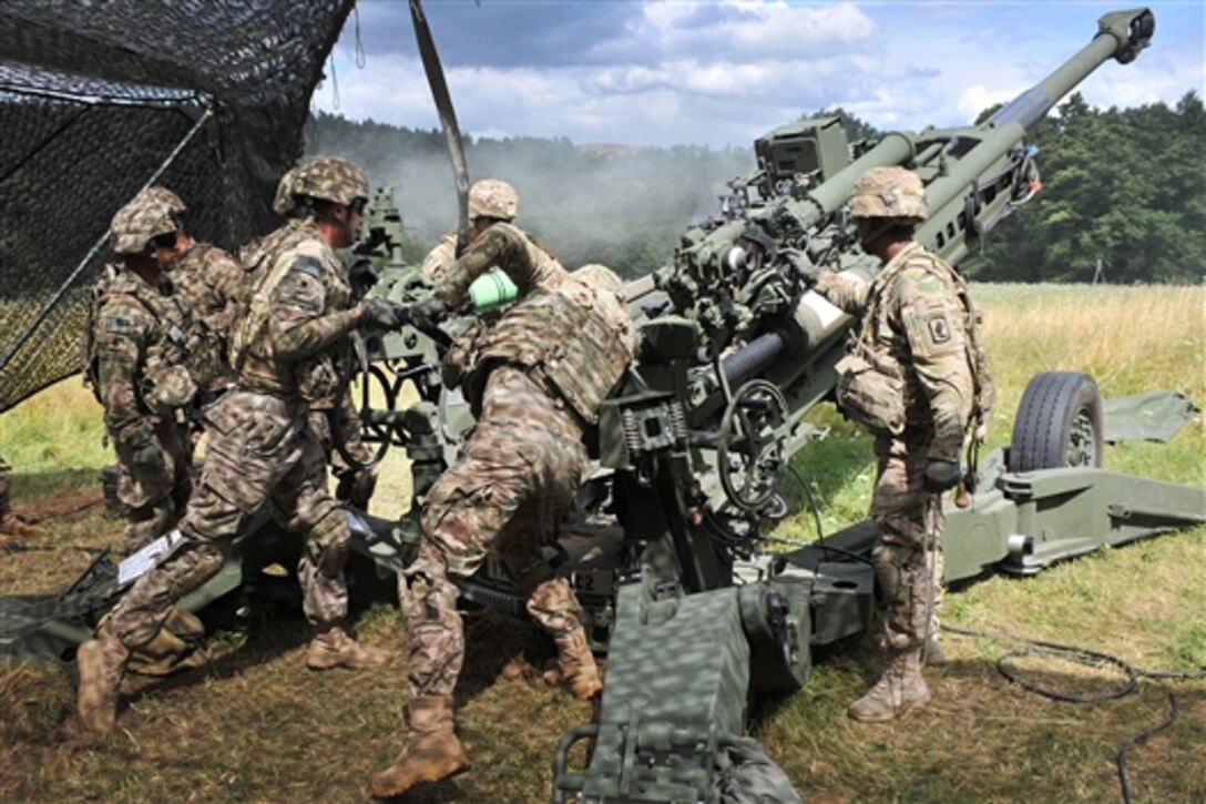 U.S. paratroopers load an M119A2 howitzer to support British army units during exercise Wessex Storm at the 7th Army Joint Multinational Training Command’s Grafenwoehr Training Area, Germany, July 28, 2015. The paratroopers are assigned to 4th Battalion, 319th Airborne Field Artillery Regiment, 173rd Airborne Brigade. 