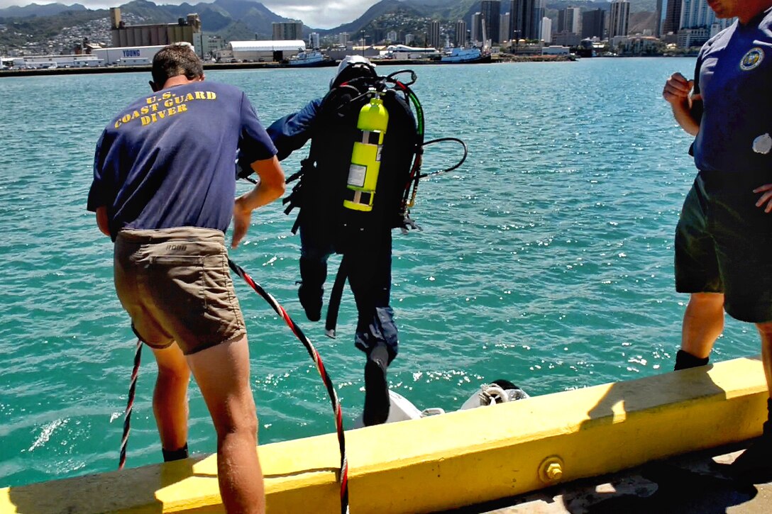 Navy Petty Officer 1st Class David Partin, Center, Jumps Into The 