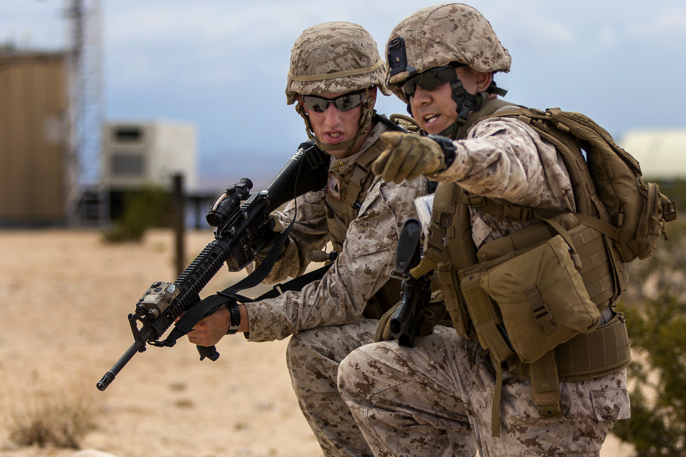 A Marine points in the direction of the next objective on a security