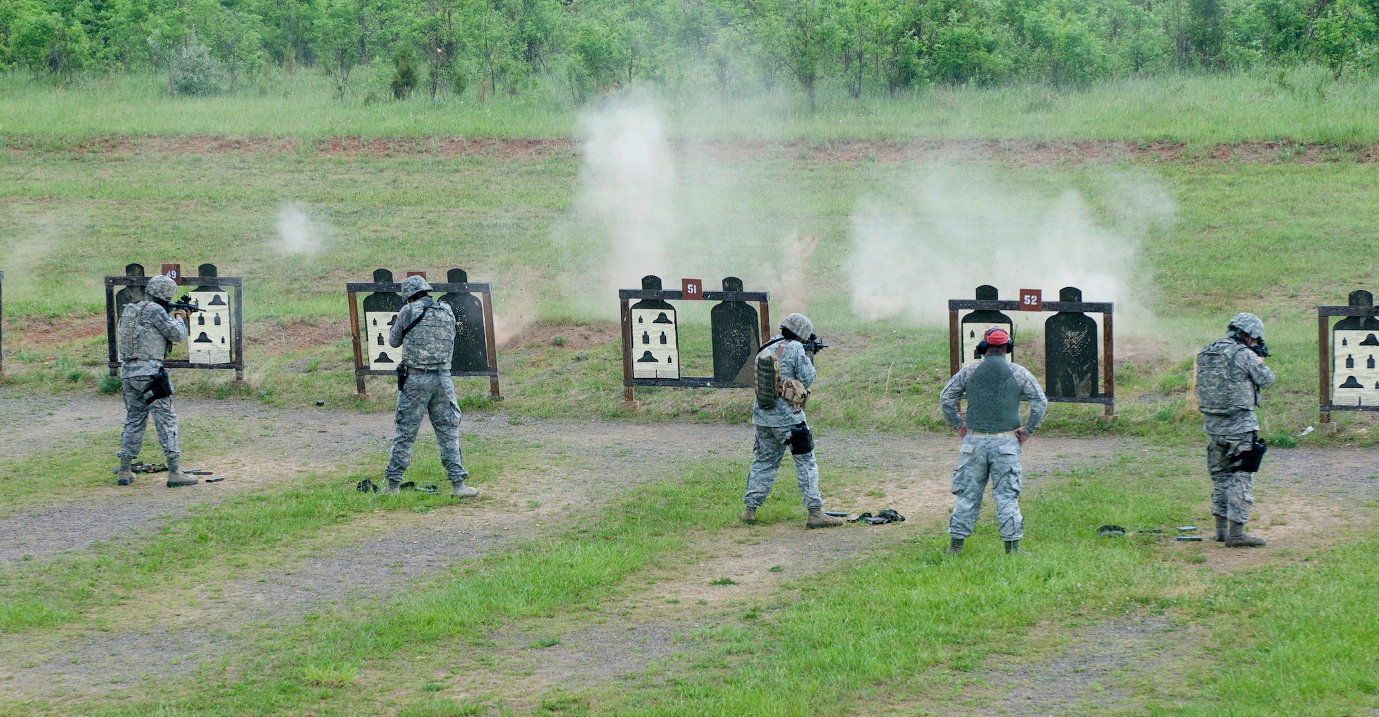 Members of the 123rd Security Forces Squadron's Combat Arms Training and Maintenance team perform threat discrimination exercises as part of annual weapons qualifications training at Fort Knox, Kentucky, May 16, 2015. The Kentucky Air National Guard CATM team trains Airmen on the use of small arms and oversees the maintenance of weapons. (U.S. Air National Guard photo by Staff Sgt. Vicky Spesard)