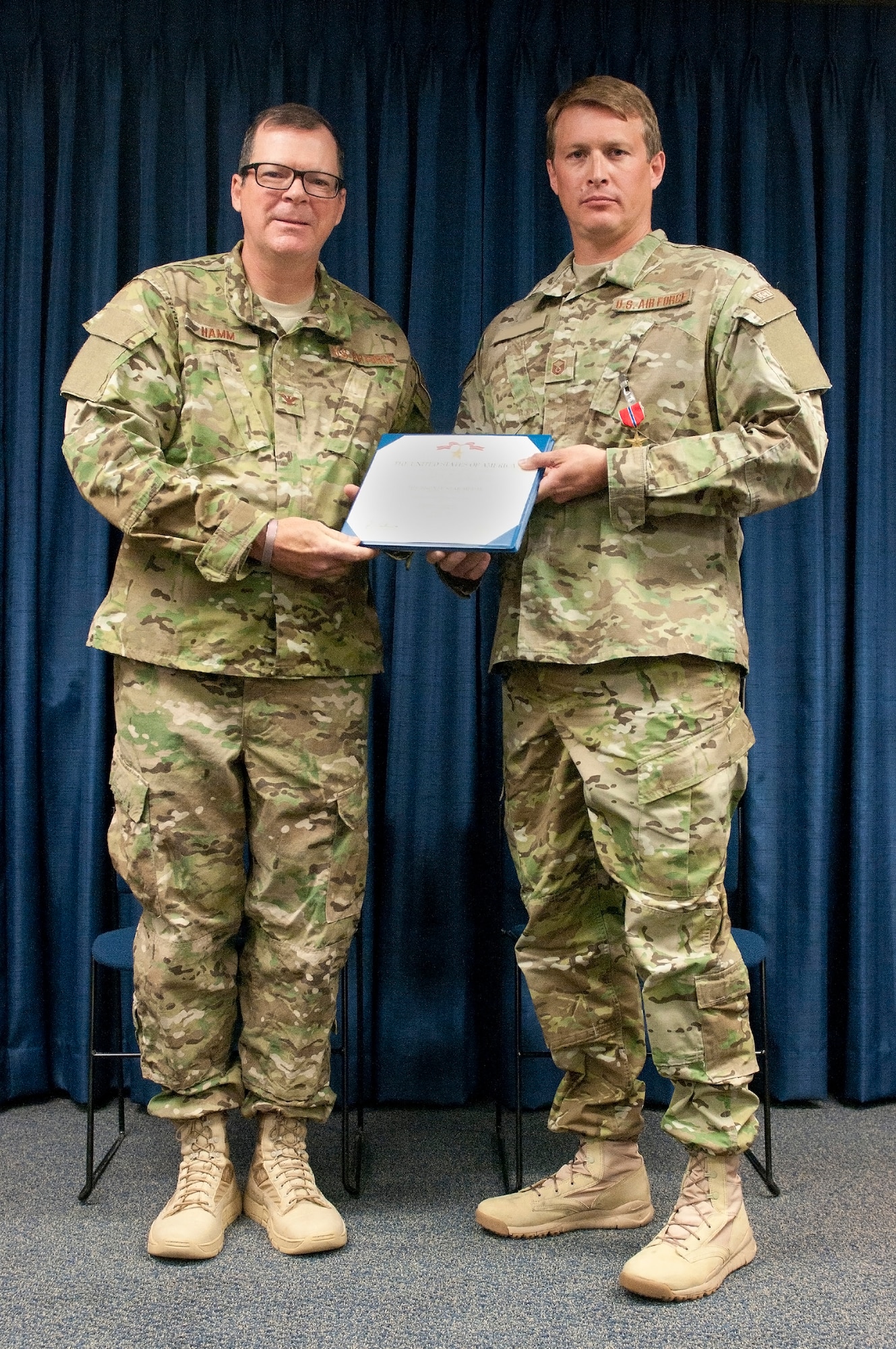 Master Sgt. Benjamin (right), a combat controller with the 123rd Special Tactics Squadron, is awarded the Bronze Star Medal during a ceremony at the Kentucky Air National Guard Base in Louisville, Ky., June 6, 2015. The medal, presented by Col. Robert Hamm, commander of the 123rd Operations Group, was awarded for meritorious service while conducting operations in support of Operation Inherent Resolve. (U.S. Air National Guard photo illustration by Staff Sgt. Vicky Spesard)
