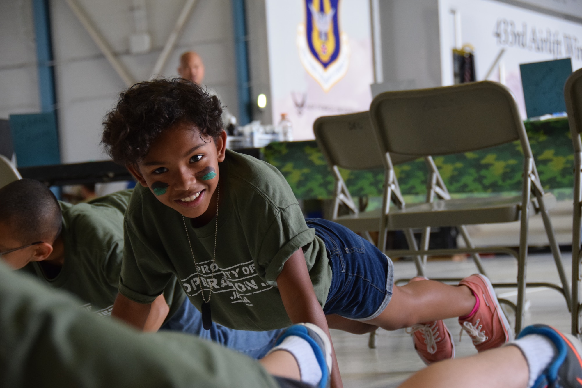Mia Charles was one of 200 children who participated in Operation JET at Joint Base San Antonio-Lackland, Texas on July 31, 2015. One of the five stations she visited was the physical fitness area to do push ups, the obstacle course and agility challenges. (U.S. Air Force photo/Tech. Sgt. Carlos J. Trevino)