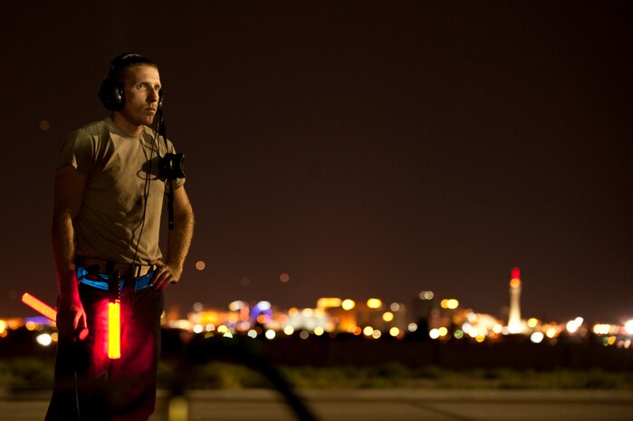 Staff Sgt. Shane Myers, a crew chief assigned to the 20th Aircraft Maintenance Squadron, Shaw Air Force Base, S.C., conducts pre-flight inspections on an F-16 Fighting Falcon prior to a Red Flag 15-3 night training sortie at Nellis Air Force Base, Nev., July 28, 2015. The night operations aspect of Red Flag is crucial for aircrews looking to gain experience in low-light situations, giving U.S. and coalition air forces the strategic upper hand in current and future conflicts. (U.S. Air Force photo by Senior Airman Joshua Kleinholz)

