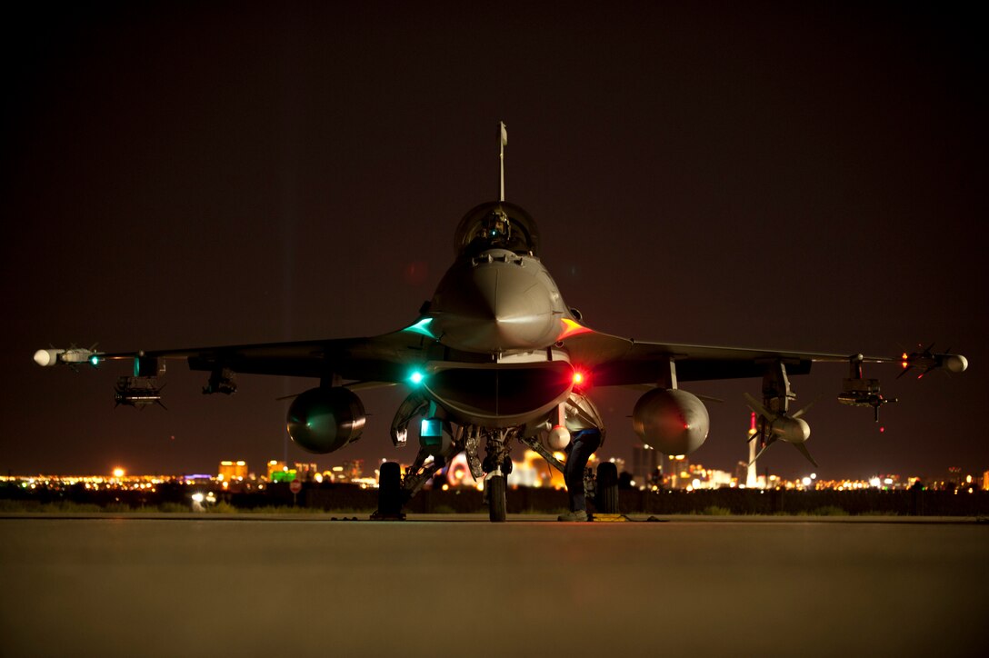 An F-16 Fighting Falcon assigned to the 55th Fighter Squadron, Shaw Air Force base, S.C., undergoes pre-flight inspections prior to a Red Flag 15-3 night training sortie at Nellis Air Force Base, Nev., July 28, 2015. During Red Flag exercises, the Nellis AFB flightline can be home to more than 150 U.S. Air Force, joint and coalition aircraft. (U.S. Air Force photo by Senior Airman Joshua Kleinholz)