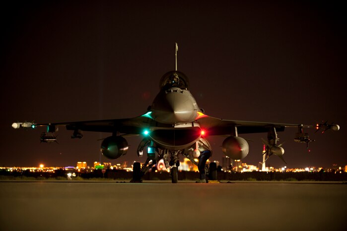 An F-16 Fighting Falcon assigned to the 55th Fighter Squadron, Shaw Air Force base, S.C., undergoes pre-flight inspections prior to a Red Flag 15-3 night training sortie at Nellis Air Force Base, Nev., July 28, 2015. During Red Flag exercises, the Nellis AFB flightline can be home to more than 150 U.S. Air Force, joint and coalition aircraft. (U.S. Air Force photo by Senior Airman Joshua Kleinholz)