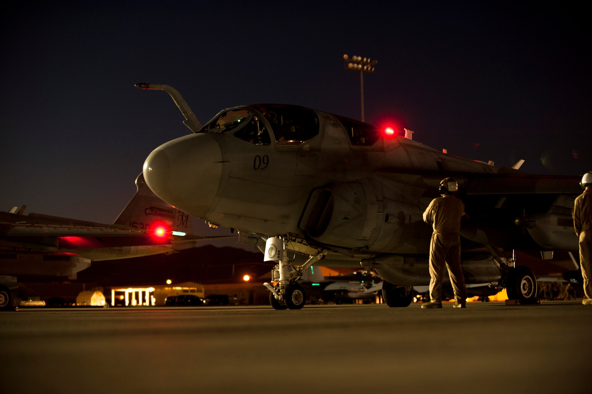 An EA-6B Prowler assigned to Marine Tactical Electronic Warfare Squadron 4, Marine Corps Air Station Cherry Point, N.C., undergoes pre-flight inspections prior to a Red Flag 15-3 night training sortie at Nellis Air Force Base, Nev., July 28, 2015. Night missions play a crucial role in Red Flag exercises, allowing aircrews and maintainers the opportunity to test their skills in challenging low-light conditions. (U.S. Air Force photo by Senior Airman Joshua Kleinholz)