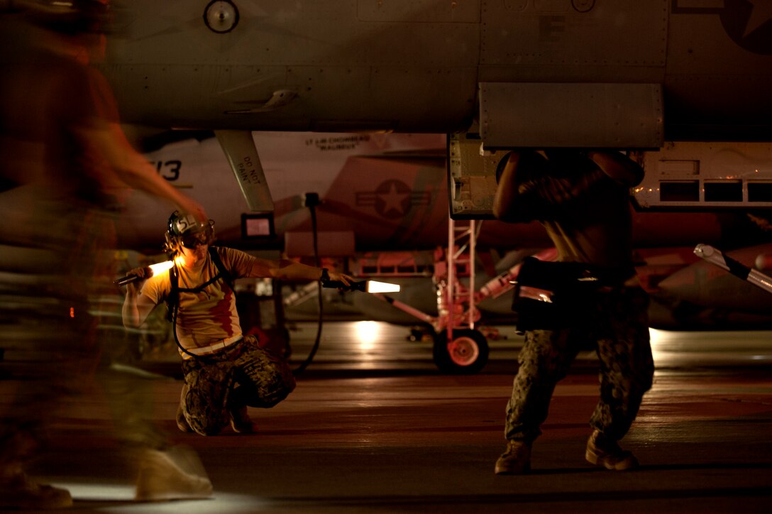 U.S. Navy sailors assigned to Electronic Attack Squadron 138, Whidbey Island, Wash., conduct pre-flight inspections on an EA-18G Growler prior to a Red Flag 15-3 night training sortie at Nellis Air Force Base, Nev., July 28, 2015. Red Flag gives aircrews and air support operations service members from various airframes, military services and allied countries an opportunity to integrate and practice combat operations. (U.S. Air Force photo by Senior Airman Joshua Kleinholz)