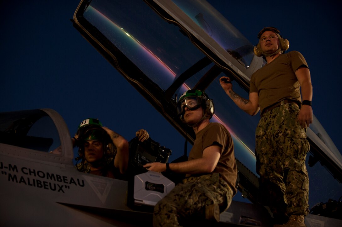 U.S. Navy sailors assigned to Electronic Attack Squadron 138, Naval Air Station Whidbey Island, Wash., conduct pre-flight inspections on an EA-18G Growler prior to a Red Flag 15-3 night training sortie at Nellis Air Force Base, Nev., July 28, 2015. The introduction of low-visibility conditions presents aircrews with a number of challenges that test their ability to perform the mission at any time; day or night. . (U.S. Air Force photo by Senior Airman Joshua Kleinholz)