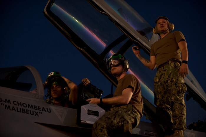 U.S. Navy sailors assigned to Electronic Attack Squadron 138, Naval Air Station Whidbey Island, Wash., conduct pre-flight inspections on an EA-18G Growler prior to a Red Flag 15-3 night training sortie at Nellis Air Force Base, Nev., July 28, 2015. The introduction of low-visibility conditions presents aircrews with a number of challenges that test their ability to perform the mission at any time; day or night. . (U.S. Air Force photo by Senior Airman Joshua Kleinholz)