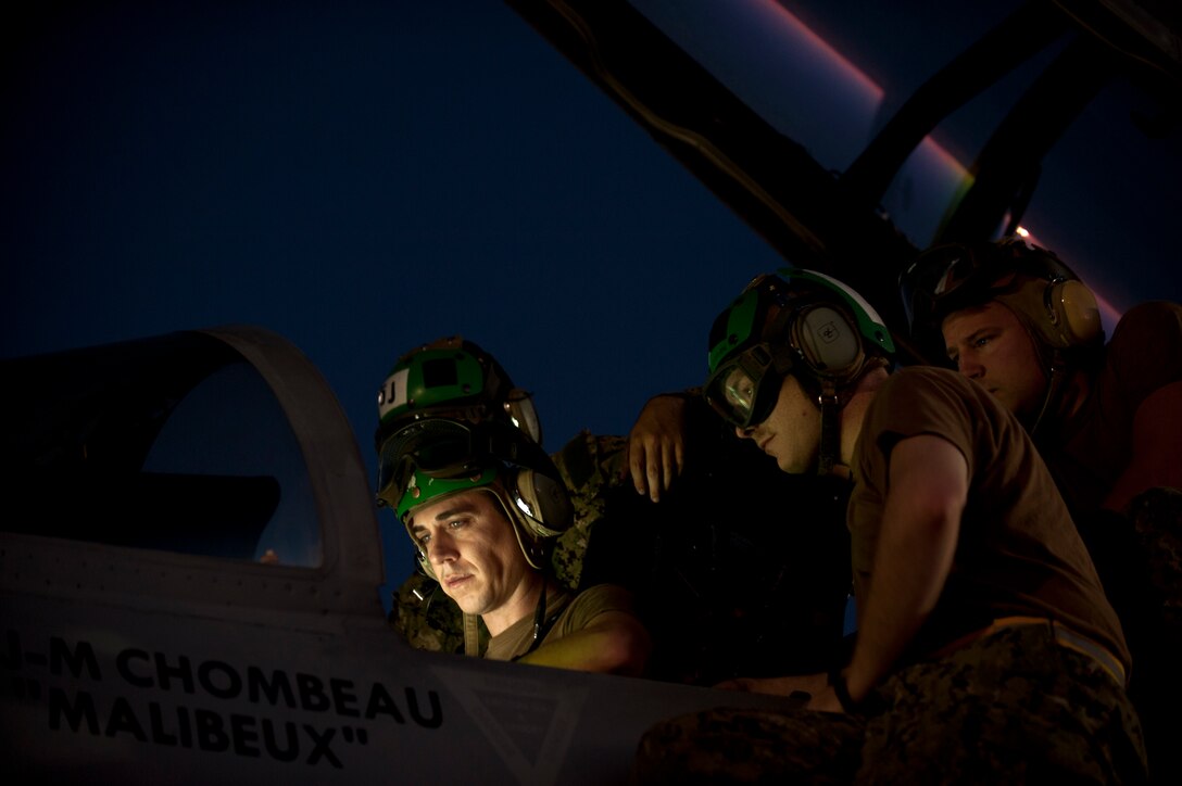 U.S. Navy sailors assigned to Electronic Attack Squadron 138, Naval Air Station Whidbey Island, Wash., conduct pre-flight inspections on an EA-18G Growler prior to a Red Flag 15-3 night training sortie at Nellis Air Force Base, Nev., July 28, 2015. The introduction of low-visibility conditions presents aircrews with a number of challenges that test their ability to perform the mission at any time; day or night. . (U.S. Air Force photo by Senior Airman Joshua Kleinholz)
