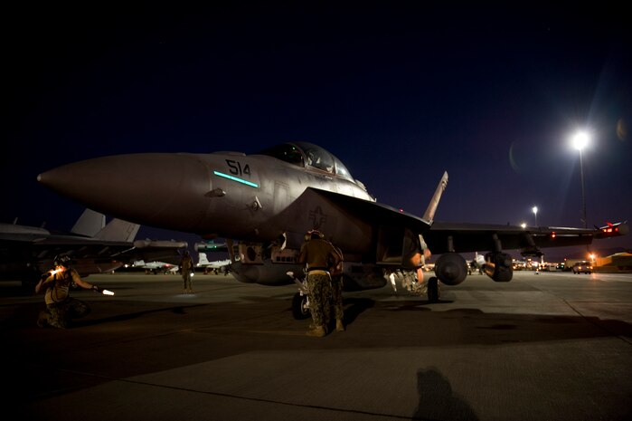 U.S. Navy aircrew members assigned to Electronic Attack Squadron 138, Naval Air Station Whidbey Island, Wash., inspect an EA-18G Growler during Red Flag 15-3 at Nellis Air Force Base, Nev., July 28, 2015. All four branches of the U.S. military and air forces from allied nations participate in Red Flag exercises held three to four times each year.  (U.S. Air Force photo by Airman 1st Class Rachel Loftis)   