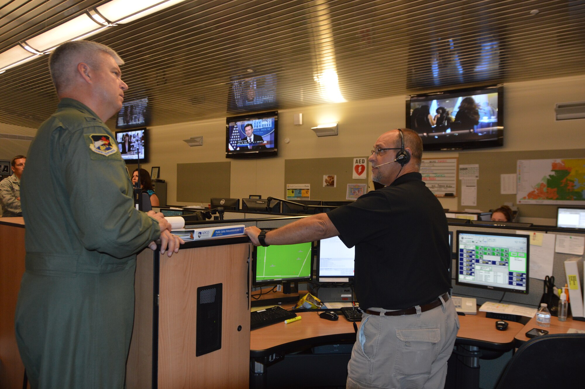 Col. Al Wimmer, Director, Continental U.S. Aerospace Defense Command Region – 1st Air Force  (Air Forces Northern)  Air and Space Operations Directorate, talks with Brian Hardin, Emergency Services  Communications Division supervisor, during a familiarization visit to the Bay County Emergency Operations Center  in Southport, Fla., July 23. During the visit, several members of CONR-1st AF (AFNORTH),  Tyndall Air Force Base, Fla., toured the facilities to learn more about how Bay County officials conduct contingency operations. (Air Force photo released/Mary McHale)