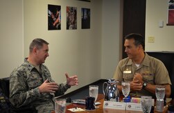 Colonel Robert Lyman, Joint Base Charleston commander, conducts an office call with CAPT Maxwell Shuman, the commanding officer of Navy Munitions Command, Continental United States East Division, based in Yorktown, Va. The Navy Munitions Command is designed to align all ashore ordnance support operations in the United States and Asia into one worldwide unit and consolidate 2,100 personnel under three divisions: CONUS East Division, CONUS West Division and East Asia Division. (U.S. Air Force photo/Staff Sgt. AJ Hyatt)