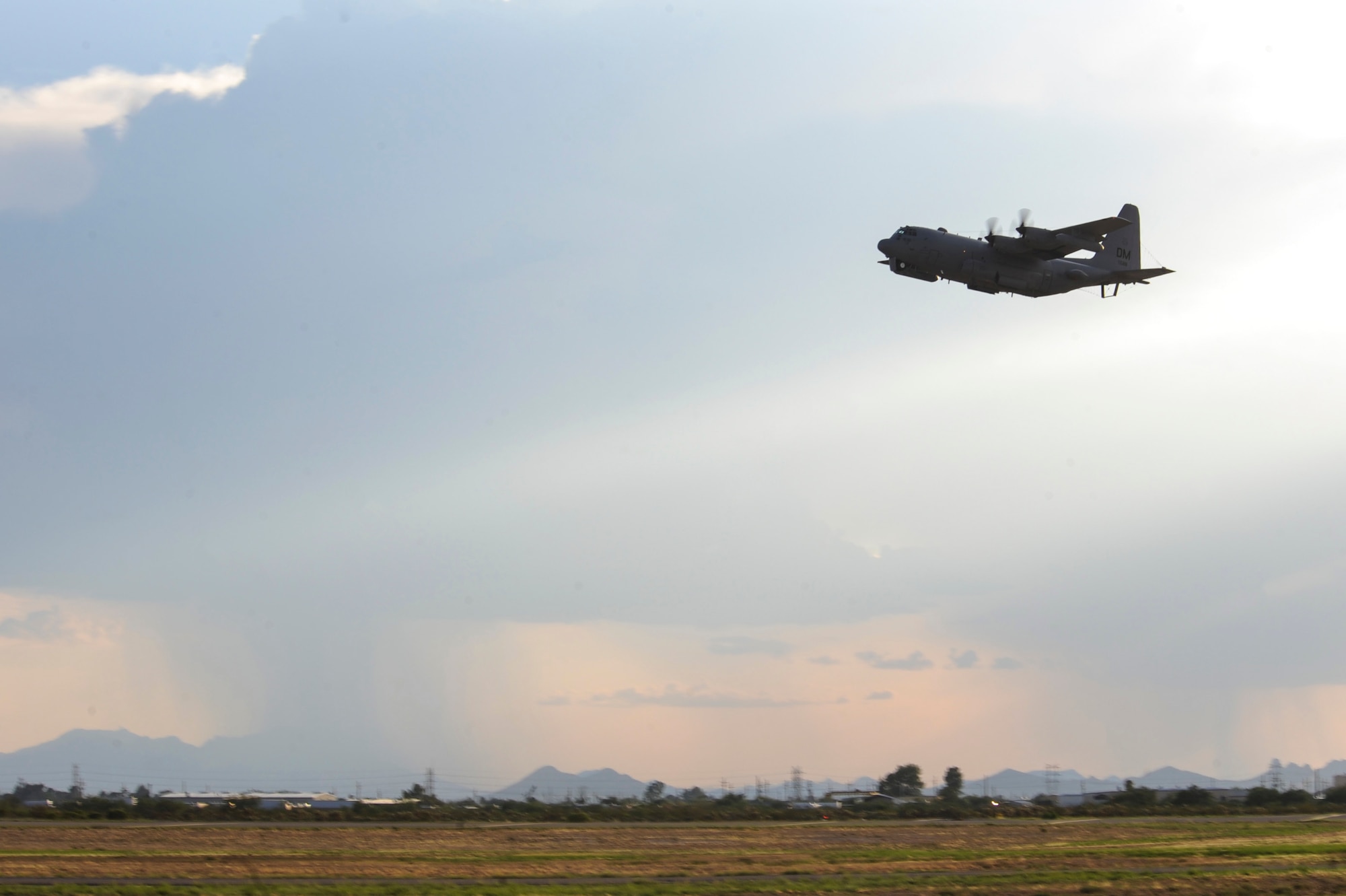 An EC-130H Compass Call from the 41st Electronic Combat Squadron flies over Davis-Monthan Air Force Base, Ariz., July 15, 2015. The 41st ECS provides war-fighting commanders with combat ready EC-130H Compass Call aircraft and aircrews trained to execute electronic attack and information warfare strategy. (U.S. Air Force photo by Airman 1st Class Cheyenne Morigeau/Released)