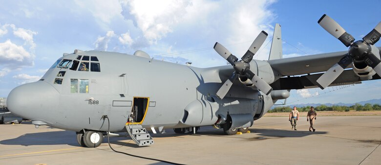 U.S. Marine Corps Capt. Jonathon Leach, 41st Electronic Combat Squadron mission crew commander inspects an EC-130H Compass Call on the flightline at Davis-Monthan Air Force Base, Ariz., July 15, 2015. Leach is from Marine Corps Air Station Cherry Point, NC, where he flies on the EA-6B Prowler. Leach is part of a three-year inter-service exchange program where he will be flying on the EC-130H Compass Call with the 41st ECS. (U.S. Air Force photo by Airman 1st Class Cheyenne Morigeau/Released) 